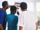 three person looking at x ray result