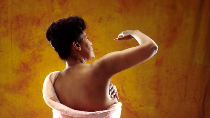 Photo by National Cancer Institute woman in white bath towel holding her hair