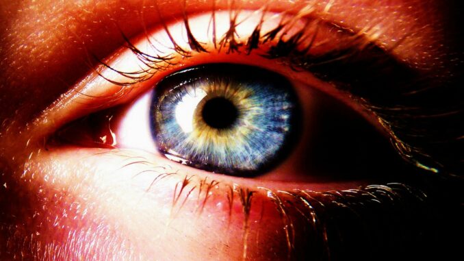 a close up of a person's blue eye
