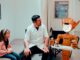 Doctor, girl, and robot in a medical room.