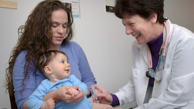 a young child is being examined by a doctor