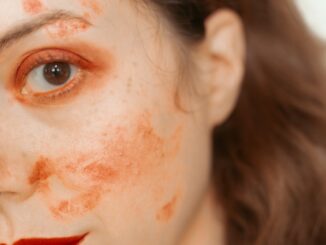 Woman with red paint smudges on face