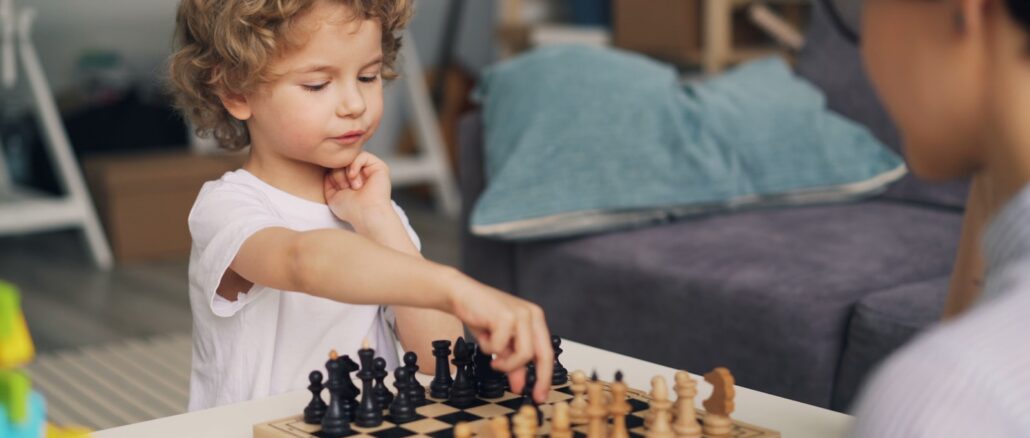 a little boy playing a game of chess