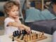 a little boy playing a game of chess