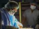Surgeons in sterile gowns and masks performing surgery